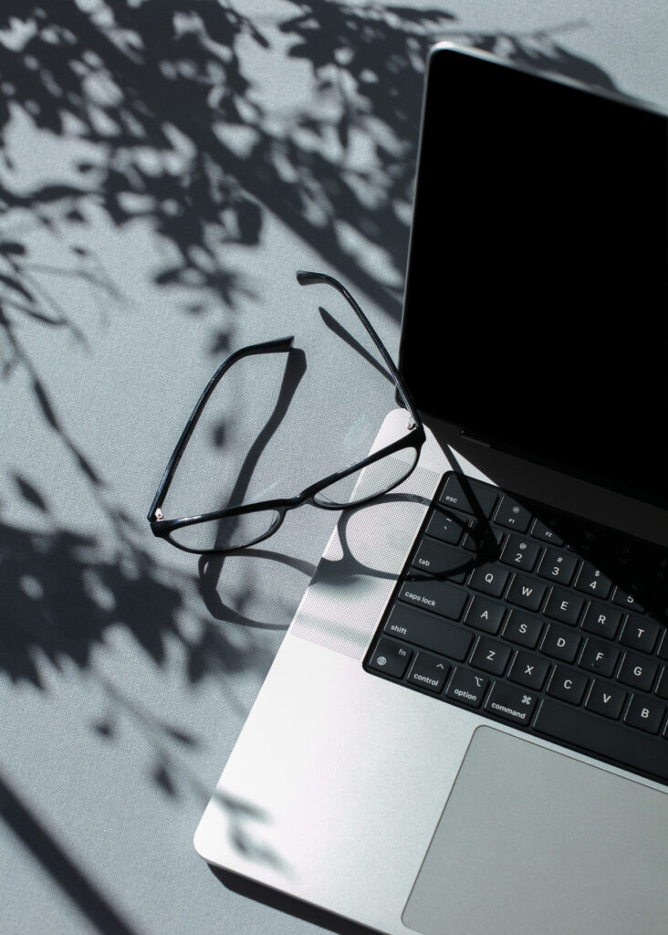 Stock image of laptop and glasses to illustrate getting multiple quotes from trades and comparing them