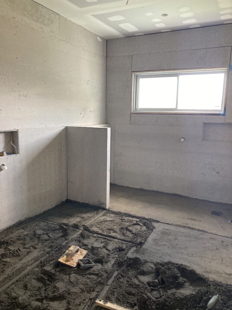 Photo of the screed being applied to the bathroom floor