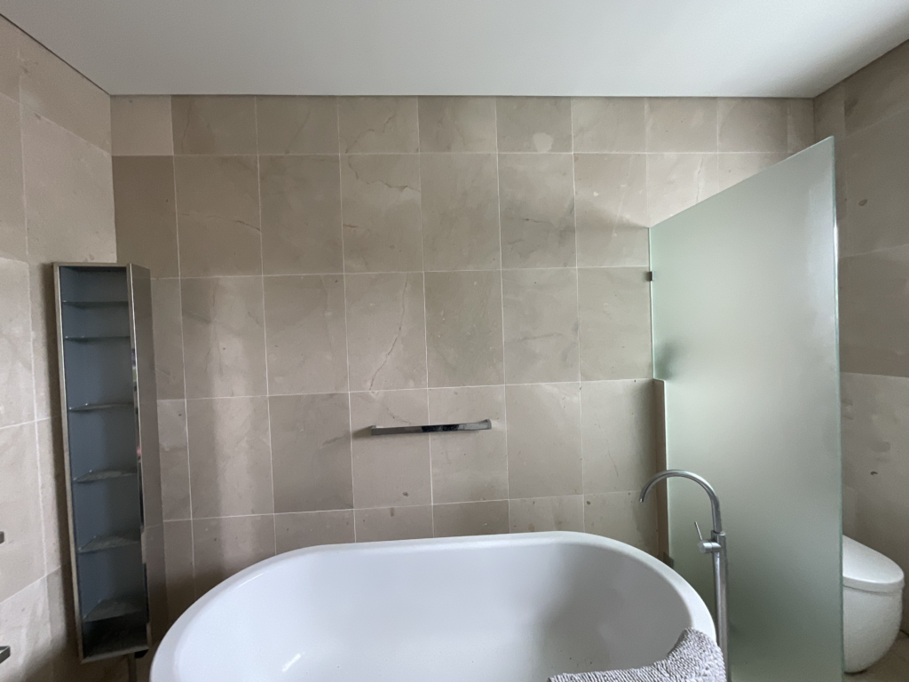 Before image of the bathroom renovation in Sydney showing the bathroom wall