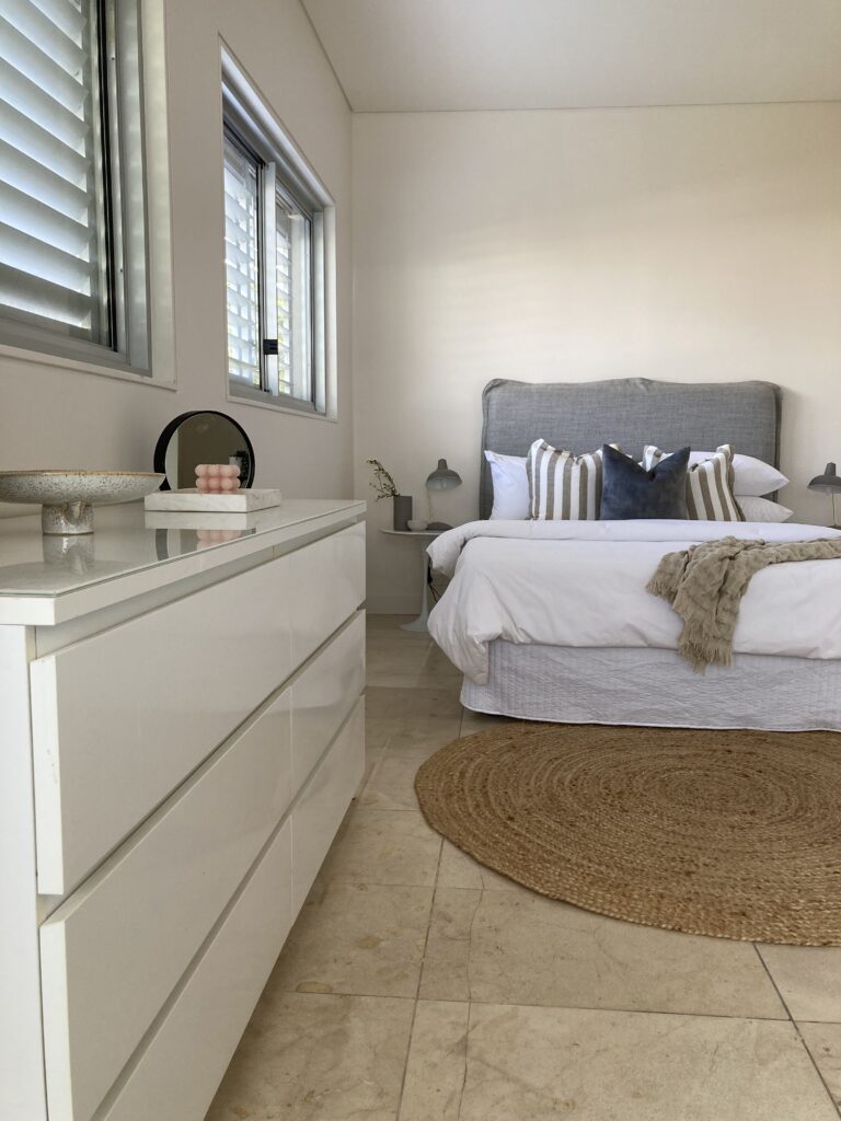 Bed, dresser and styling in the 5th bedroom