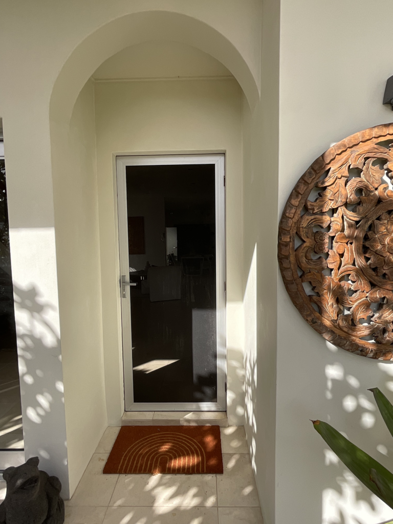 Front door of 88 Clareville Avenue. The magnolia trees cast beautiful shadows on the entryway