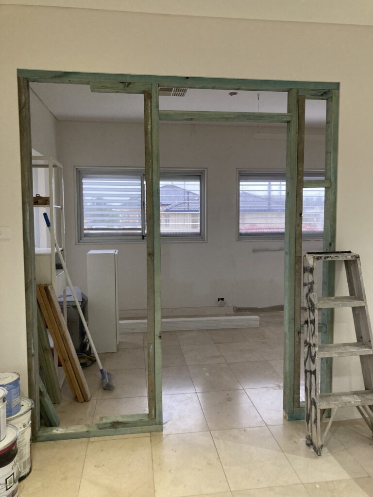 Progress photo of the bedroom renovation showing framing in of the doorway leading into the new bedroom