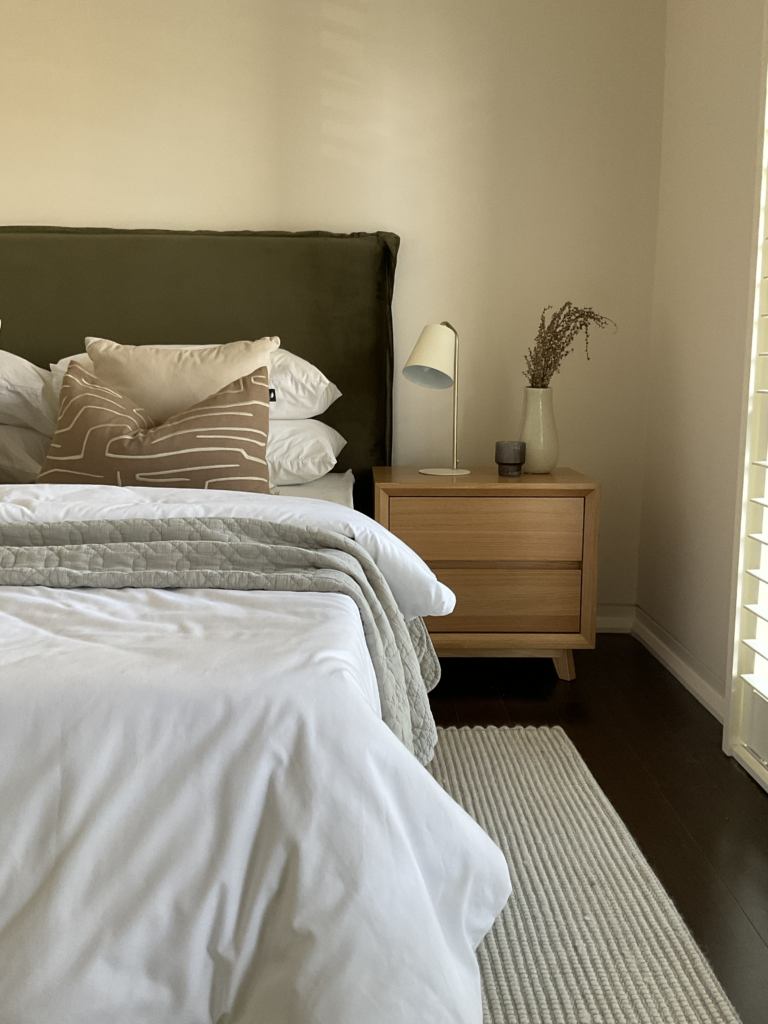 Bed and side table in the main bedroom