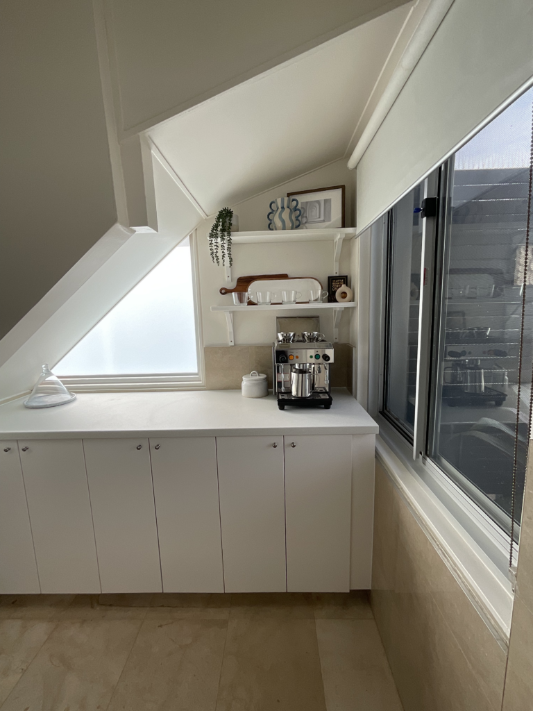 Full shot of the lower cabinets and open shelves of the pantry. 