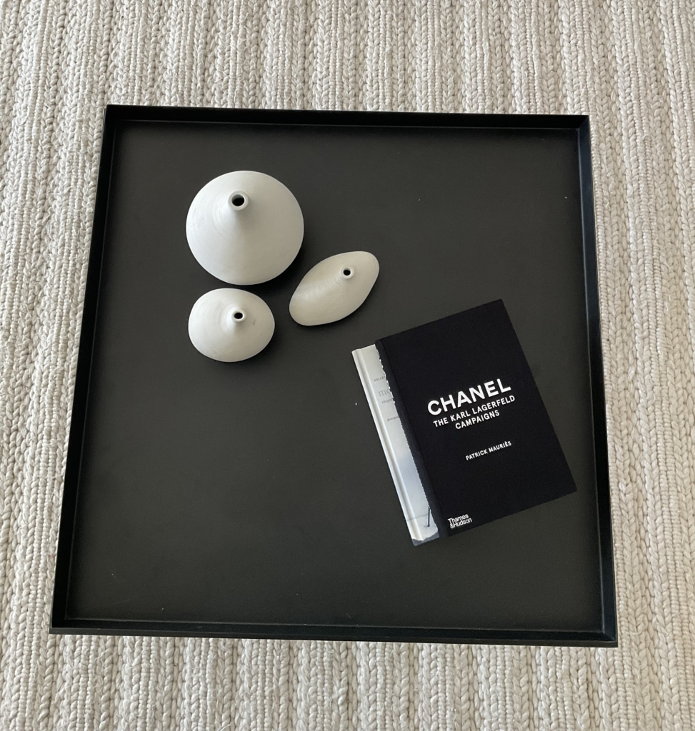 Overhead shot of the family room coffee table with Chanel book and vases