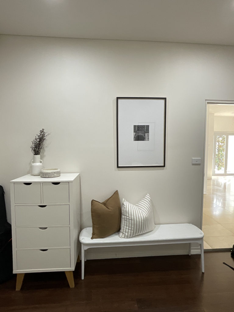 Bench and dresser with Paris artwork in the downstairs bedroom