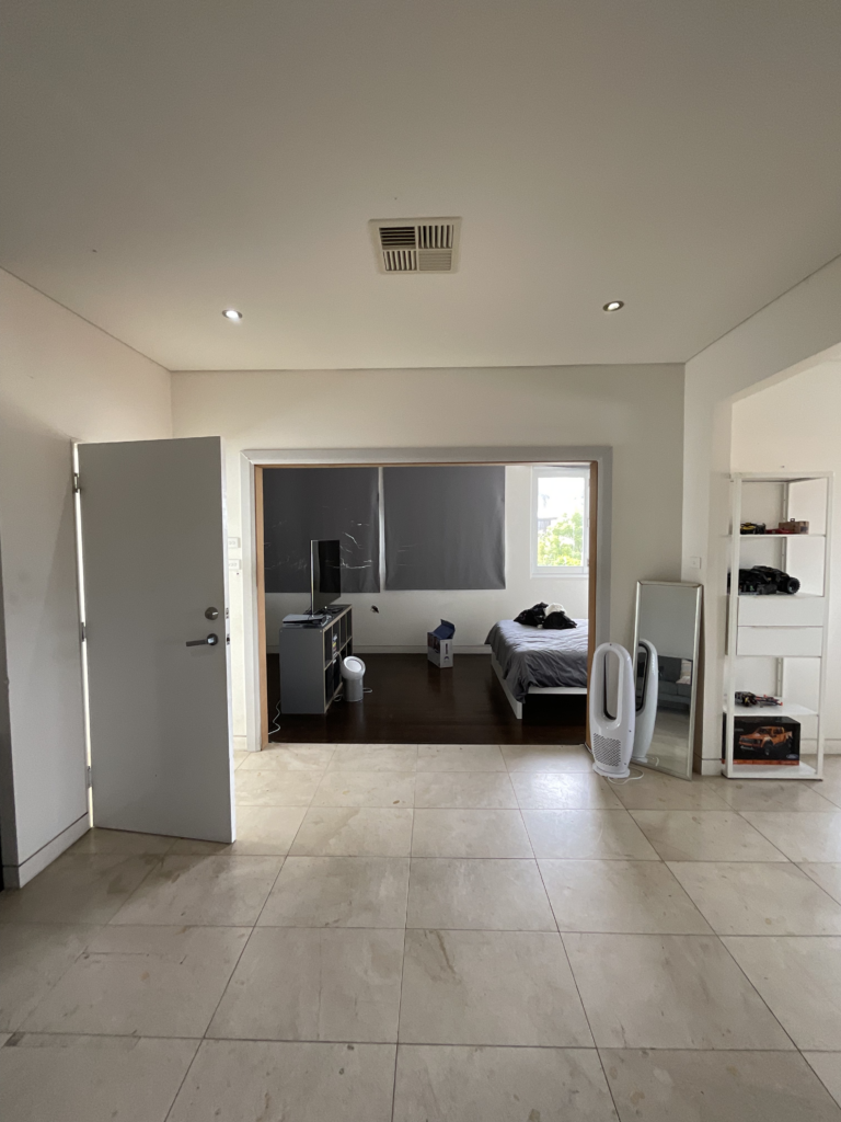 Before image of the home office renovation looking from the family room into what used to the a studio bathroom. 