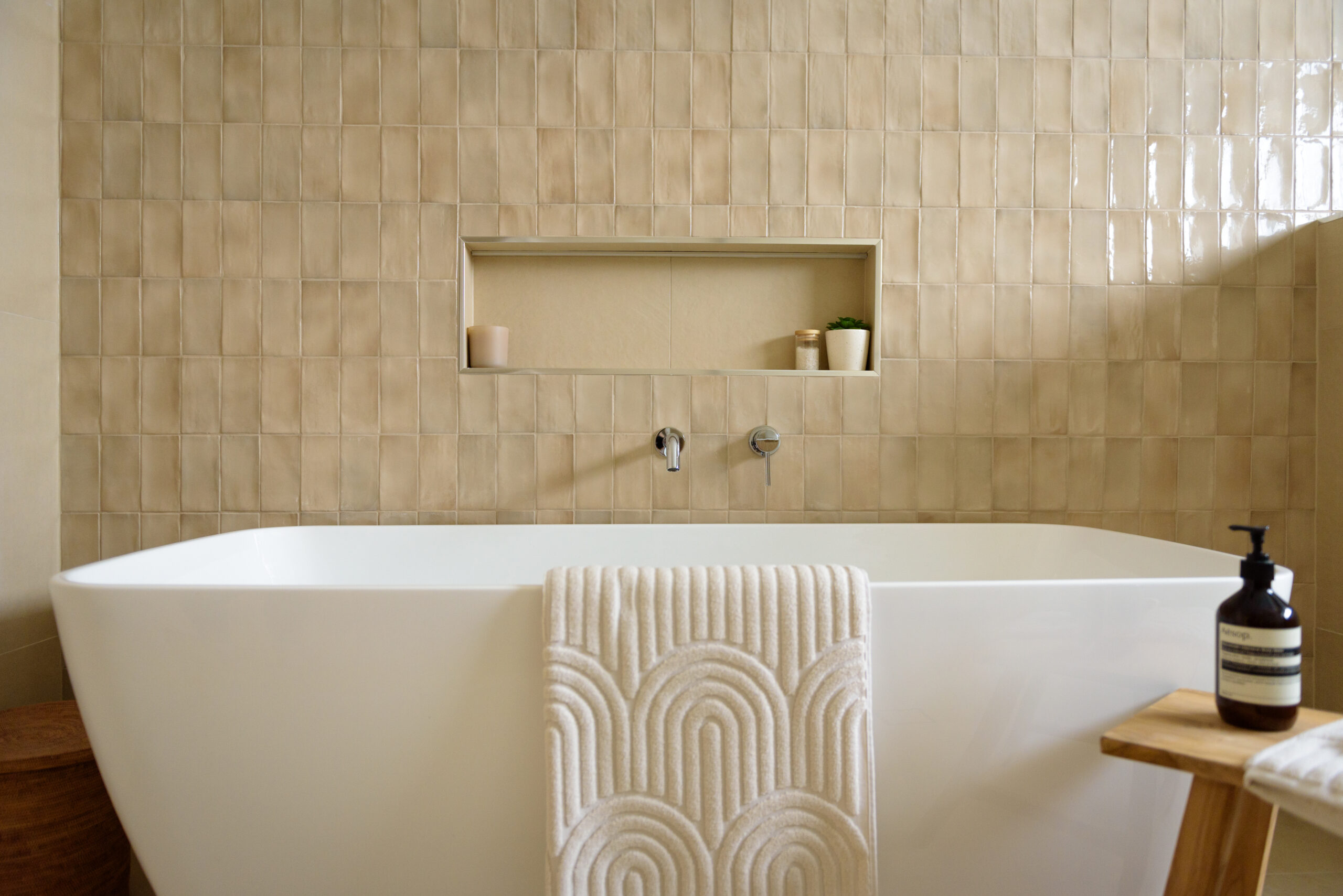 Image of the bathroom renovation in Sydney with a bathtub, feature tile wall and niche