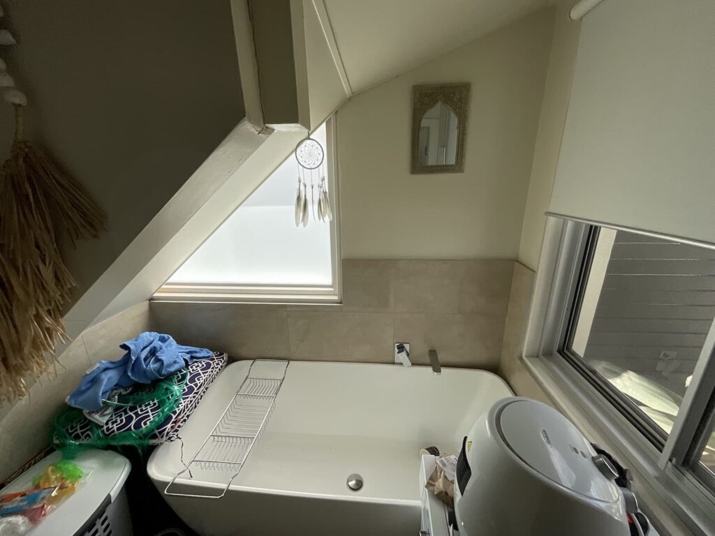 The awkward space was used for storage and had a working bathtub