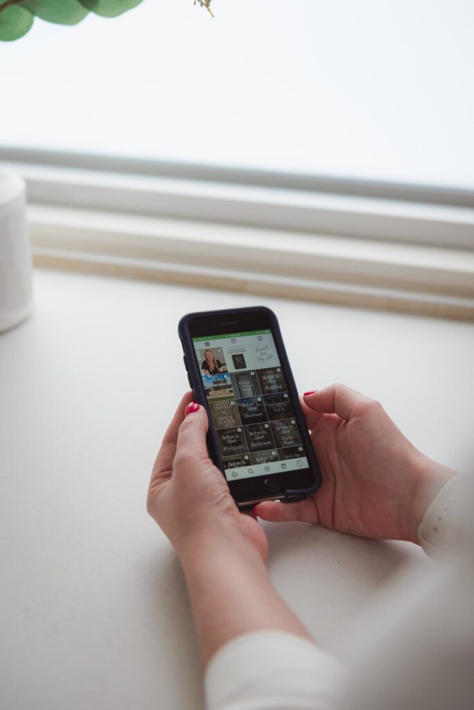 Kristen holding her phone, open to her Instagram account showing all the posts she did to market the Sandringham pre-sale renovation