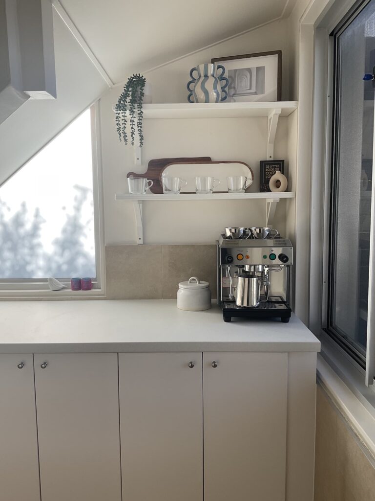 Full shot of the lower cabinets and open shelves of the pantry.