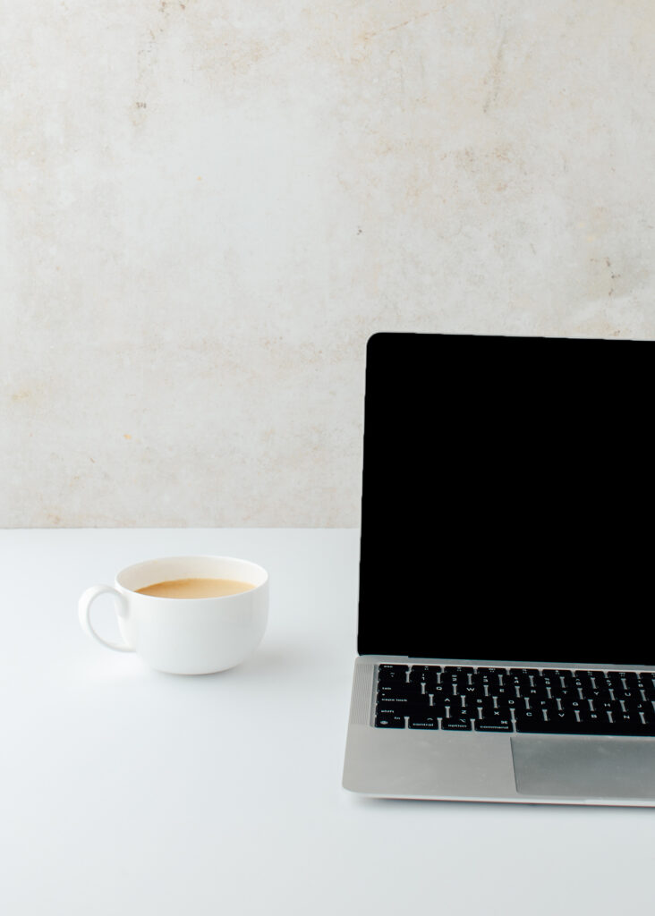 Stock image of laptop and coffee to illustrate that you'll need a computer, tablet or phone to access the home value and renovation calculator