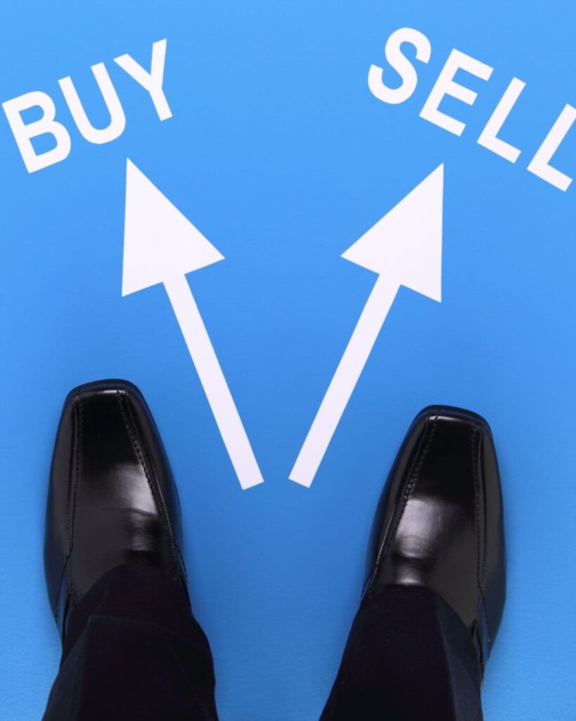 Stock image of shoes standing before two arrows, one leading to buy and one leading to sell to show the choice sellers have of what to do first