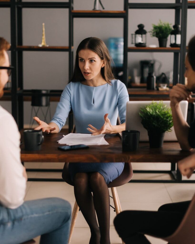 Stock image of a real estate agent talking to potential home sellers