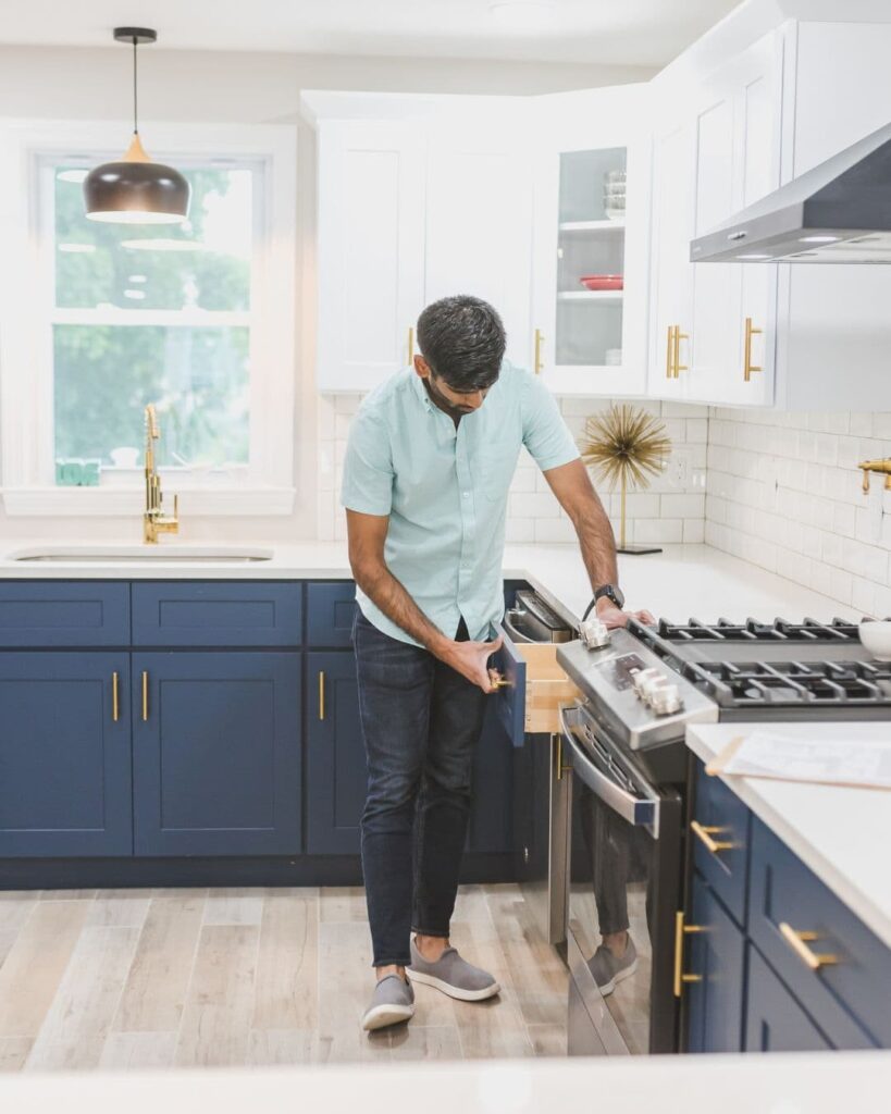 Stock image of a buyer opening a kitchen drawer to show that buyers will scrutinize properties more closely