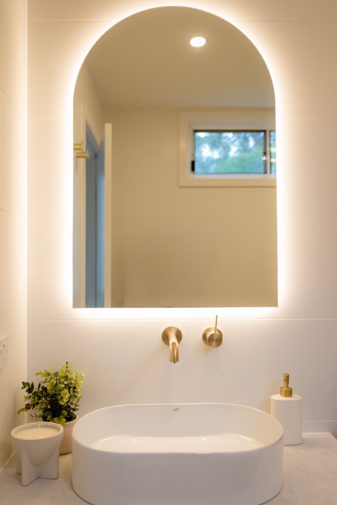 Close up of the sink and mirror in the updated bathroom