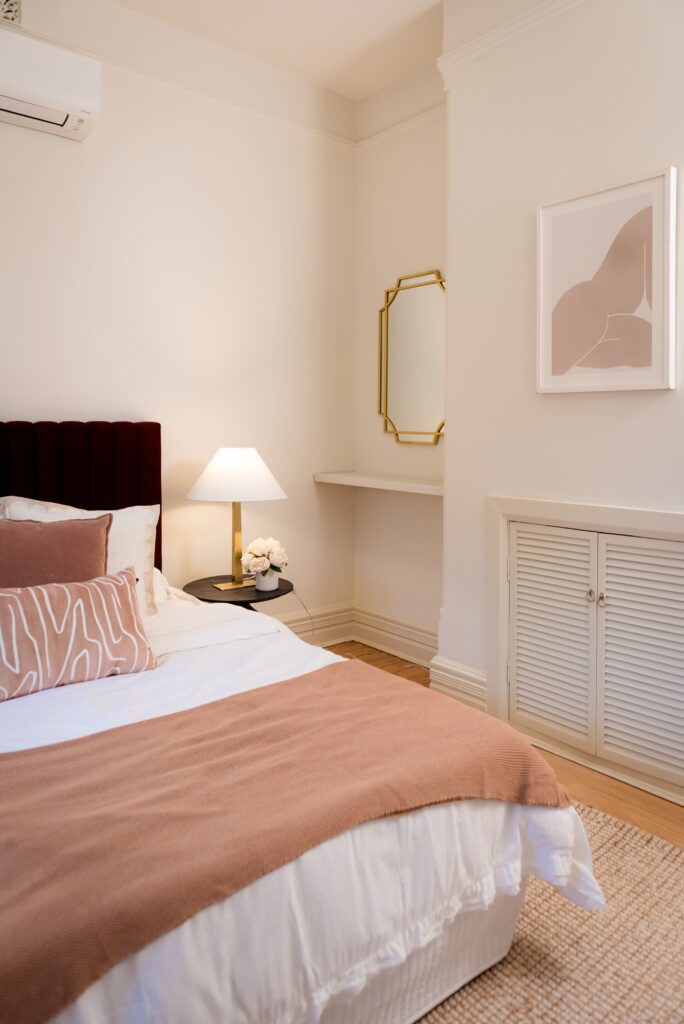 After image of the main bedroom with a split cooling system and styling