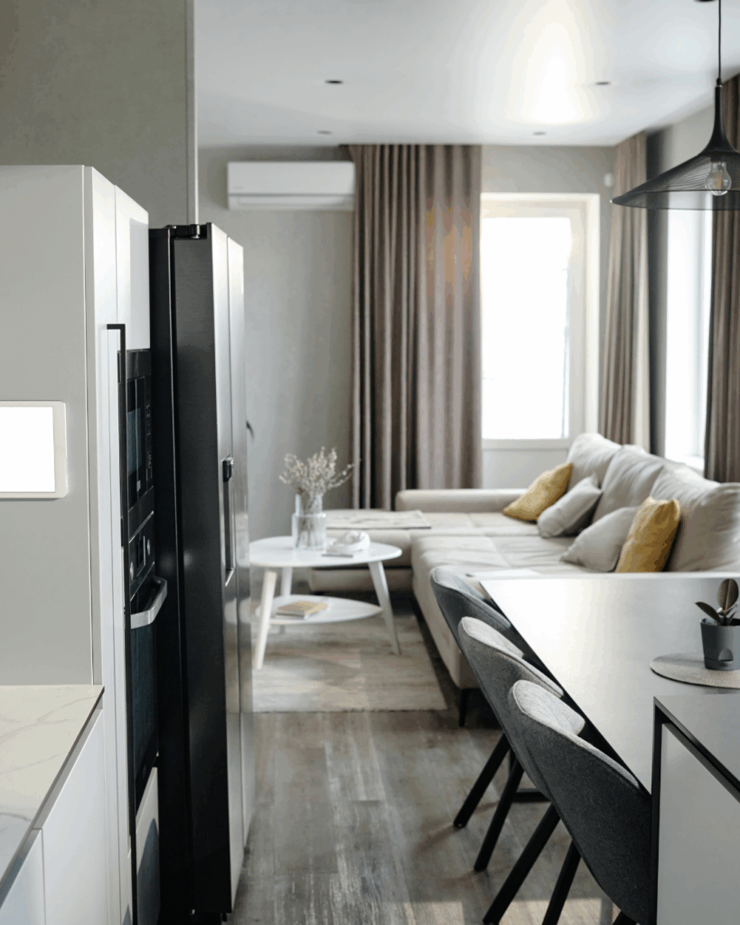 Stock image of a granny flat with a small kitchen, dining table and living room to show that the term "granny flat" is the top search term for Sydney buyers